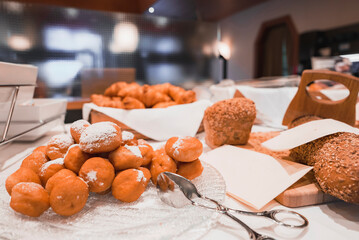 Delicious panoramic view of the buffet table with waffle and donut in a luxury hotel. Closeup of fresh food served in tray at table in restaurant
