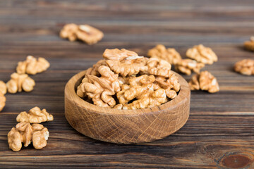 Fresh healthy walnuts in bowl on colored table background. Top view Healthy eating bertholletia concept. Super foods