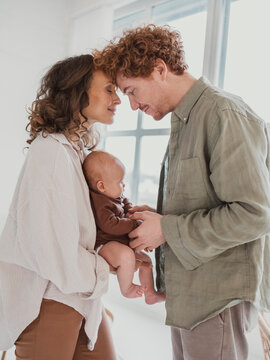 Romantic parents with son standing at home