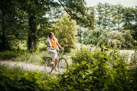 Woman riding bicycle amidst trees