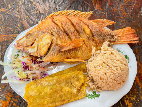 Fried fish with coconut rice, typical Colombian food