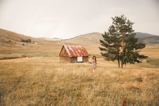 Woman standing in front of lonely building