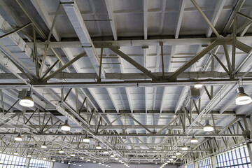 Indoor view on a roof steel beam structure in Industrial factory. Background of factory ceiling.