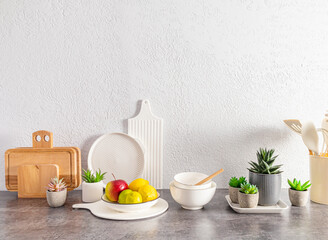 Beautiful kitchen background with a set of various environmentally friendly dishes, cutting boards, fruits in a bowl. space for text.