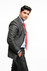 Young indian businessman in classic suit giving expression on white background.