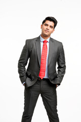 Young indian businessman in classic suit giving expression.