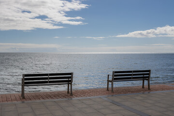Naklejka na ściany i meble Two empty benches and Atlantic ocean, Spain