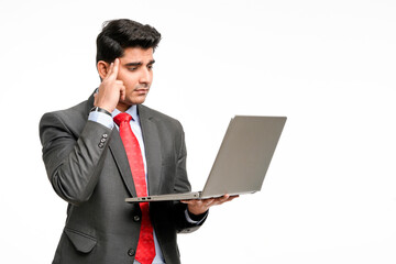 Young indian Businessman in stress while using laptop.