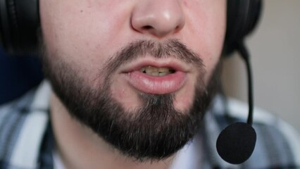 Support operator is talking with headset microphone. Call center operator. Closeup of mouth, shallow depth of field