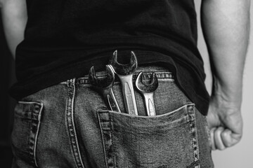 Man with wrenches in back pocket of his jeans. Ideal for industrial, mechanical, and DIY projects....