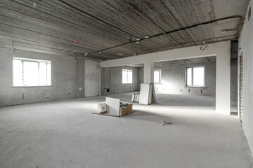 Spacious empty rooms in the attic floor after filling out the work on the wall and ceiling