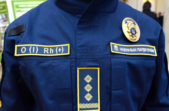 Upper part of Ukrainian police uniform, cold-climate clothing: coat, chevron, police badge, patch with blood type