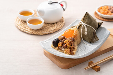 Zongzi, rice dumpling for Dragon Boat Festival on wooden table background with ingredient.