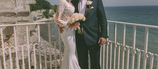 Bridal couple on a balcony by the sea - 588325857