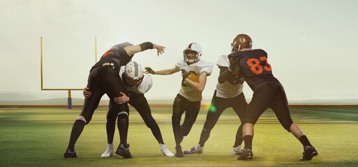 Professional american football players, men in uniform during game, training at open air 3D field with gate at daytime. Concept of sport, competition, action and motion, game, championship