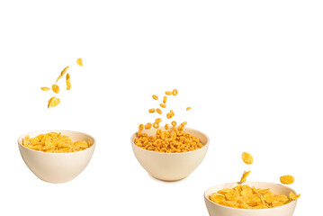 Corn flakes falling to the white bowl. Motion.