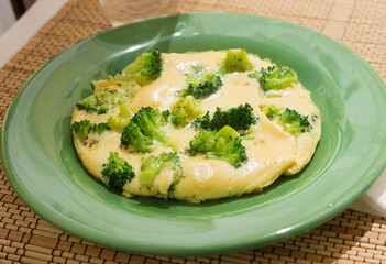 wholesome breakfast. omelet with broccoli on green plate