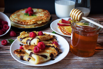 Delicious pancakes with berries and honey. Sweet food. Morning