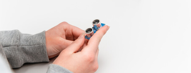 Student girl hand Learning To Program Robot Ultrasonic distance sensors facing Arduino nano board....