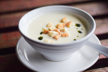 mushroom soup in bowl on wooden table