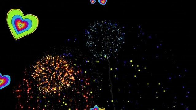 Animation of rainbow hearts over fireworks on black background