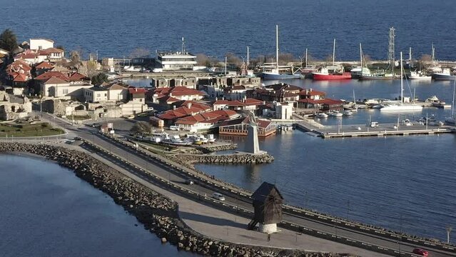Descending drone shot to wooden windmill Nesebar landmark Black Sea Bulgaria