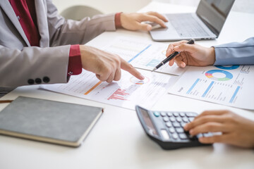 Close up hand man and woman planning budget, using calculator and laptop, reading documents, young female checking finances, counting bills or taxes, online banking services, sitting at desk