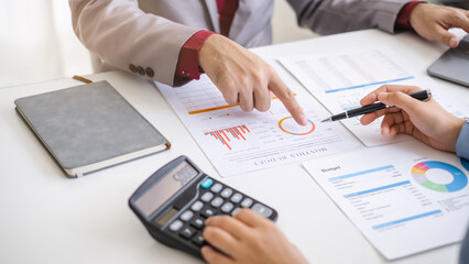 Naklejka premium Close up hand man and woman planning budget, using calculator and laptop, reading documents, young female checking finances, counting bills or taxes, online banking services, sitting at desk