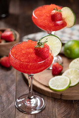 Frozen strawberry daiquiri cocktail with strawberries and lime