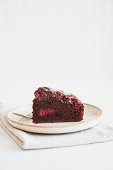 Delicious chocolate cake brownie with cherries on white wooden table
