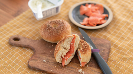 Salmon bagels on a wooden cutting board