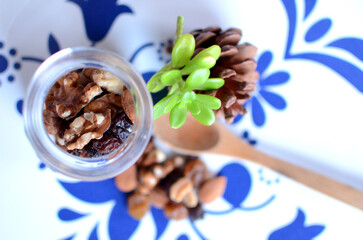  Transparent jar of Dried fruits and mix nuts with white plate. Top View