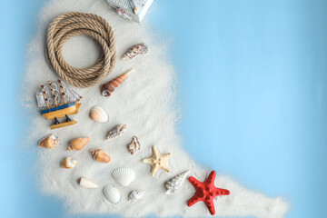 Marine summer composition. Shells, ship, rope on a blue background
