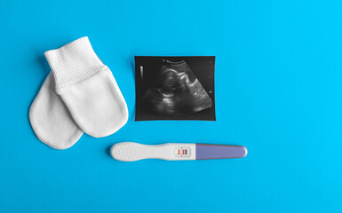 Pregnancy and ultrasound shot in a beautiful still life. There is space for text.
