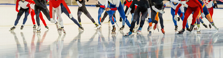 male skaters running mass start speed skating race, winter sports competition - obrazy, fototapety, plakaty