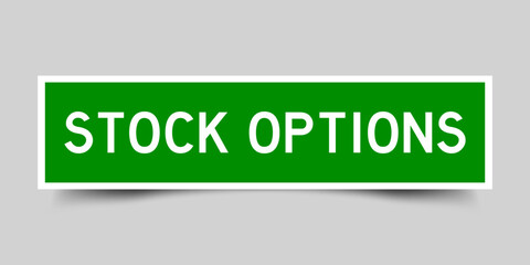 Green color square shape sticker label with word stock options stock options on gray background