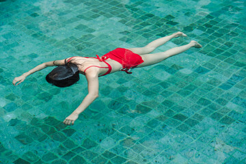 Woman in red bikini drowned in the swimming pool
