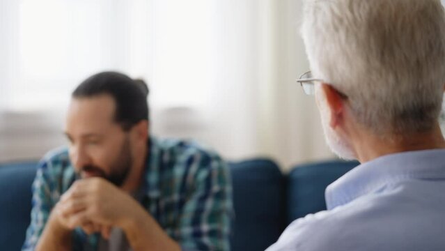 Middle-aged man pleased with psychological therapy results, happy with doctor