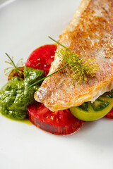 Sea bass fillet with tomatoes and pesto sauce