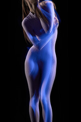 Photo of young attractive redhead male body glowing neon light over dark background. Mixed neon...
