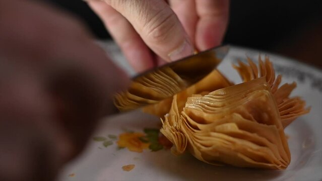 slow motion knife cutting of traditional puff pastry from cordoba argentina