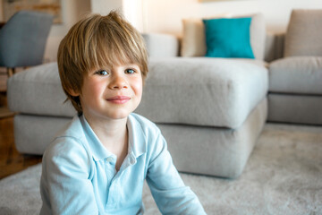 Close up portrait cute child boy smiling in living room