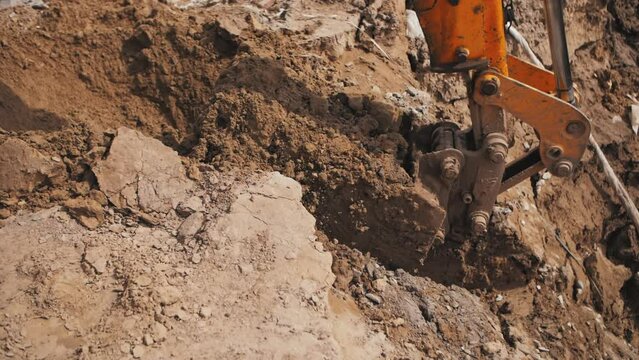excavator bucket digging the ground