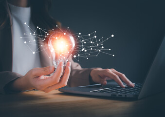 Thinking and creative concept. Businesswoman holding light blub with virtual Global Internet connection. Light bulb style bokeh vintage, Woman use computer to searching for information. new ideas.