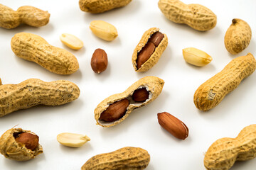 Dried peanuts in closeup on white