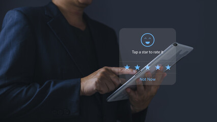 a businessman using application on tablet the virtual screen to give satisfaction in service.rating star very impressed.Customer service and Satisfaction concept.