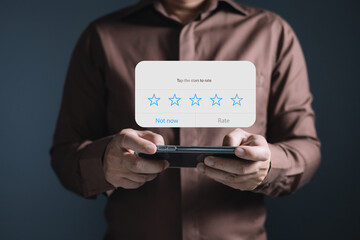 a businessman using application on smartphone the virtual screen to give satisfaction in service.rating star very impressed.Customer service and Satisfaction concept.