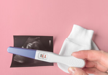 Positive pregnancy test in female hands. There is space for text.
