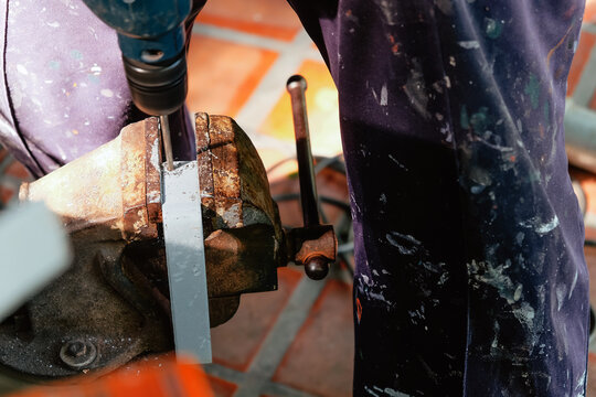 Image of Metalworker working on a drilling machine