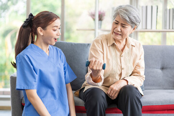 Obraz premium Asian women are being cared for by nurses who monitor health and physical therapy for elderly women living alone at home. by walking on a cane or using muscles